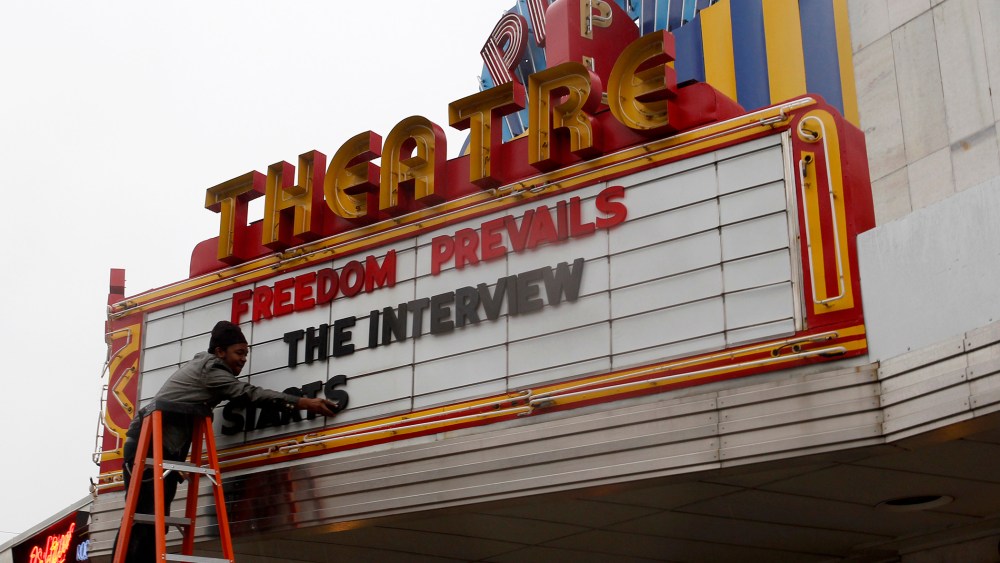 General Manager Delaney puts letters on the marquee sign after the announcement that the Plaza Theatre would be showing the movie "The Interview" in Atlanta