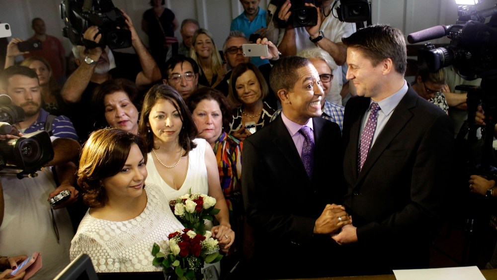 Same-sex couples Todd (2nd R), and Jeff Delmay with Catherina Pareto and Karla Arguello (L) get married at the Eleventh Judicial Circuit Court of Florida in Miami, Florida, Jan. 5, 2015. (Photo by Javier Galeano/Reuters)