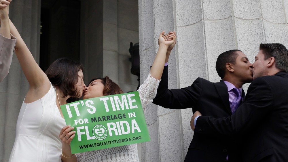 From right to left; Jeff Delmay, Todd Delmay, Karla Arguello and Catherina Pareto kiss after the same-sex couples were married in Miami, Fla. on Jan. 5, 2015. (Photo by Javier Galeano/Reuters)