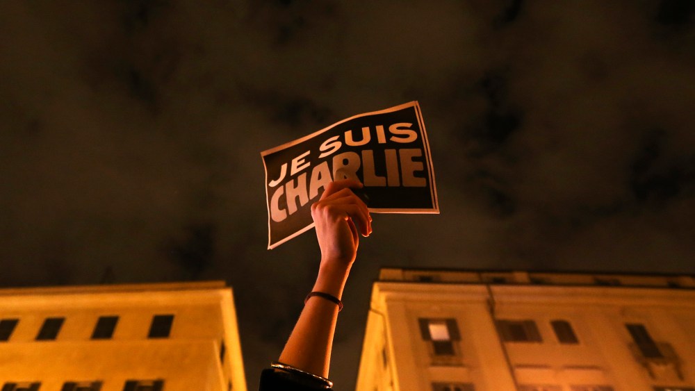 A woman holds a placard reading "I am Charlie," to pay tribute to victims following a shooting at the offices of weekly newspaper Charlie Hebdo in Paris, in front of the French embassy in Rome, Jan. 8, 2015. (Photo by Alessandro Bianchi/Reuters)