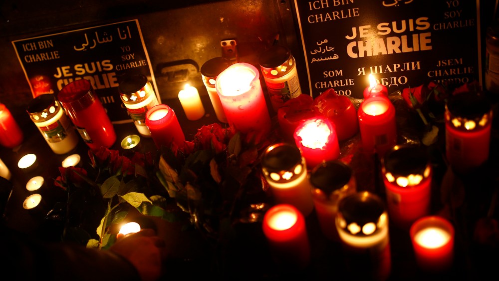 People light candles to pay tribute to victims during a vigil in Frankfurt on Jan. 8, 2015, following a shooting by gunmen at the offices of weekly satirical magazine Charlie Hebdo in Paris. (Photo Kai Pfaffenbach/Reuters)