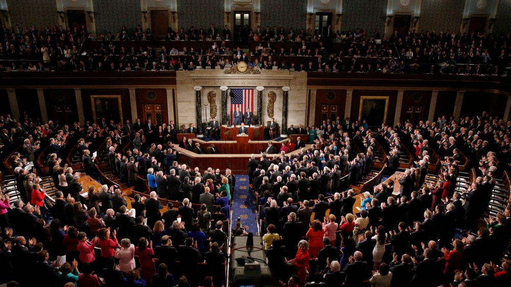 U.S. President Barack Obama (C) receives a standing ovation as he delivers his State of the Union address to a joint session of Congress in the U.S. Capitol in Washington, D.C., on Jan. 20, 2015. (Photo by Kevin Lamarque/Reuters)