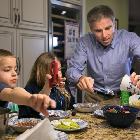 Carl Krawitt makes dinner for his son Rhett, 6, left, and daughter Annesley, 8, center, in their home in Corte Madera, Calif. on Jan. 28, 2015.