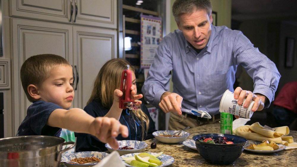Carl Krawitt makes dinner for his son Rhett, 6, left, and daughter Annesley, 8, center, in their home in Corte Madera, Calif. on Jan. 28, 2015.