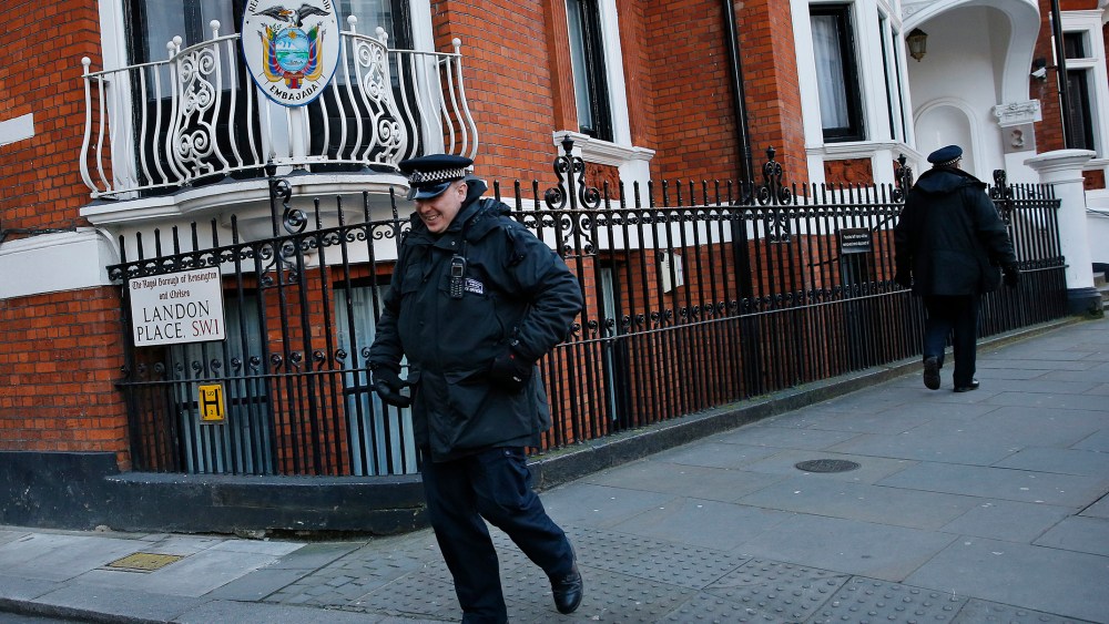 Police officers walk past the Ecuador embassy following a shift change in London, Feb. 6, 2015. (Photo by Suzanne Plunkett/Reuters)