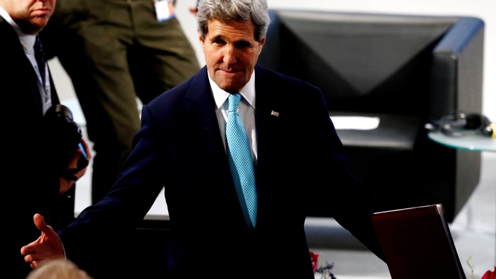 US Secretary of State John Kerry gestures as he arrives for the chairman's debate at the 51st Munich Security Conference in Munich, Feb. 8, 2015. (Photo by Michael Dalder/Reuters)