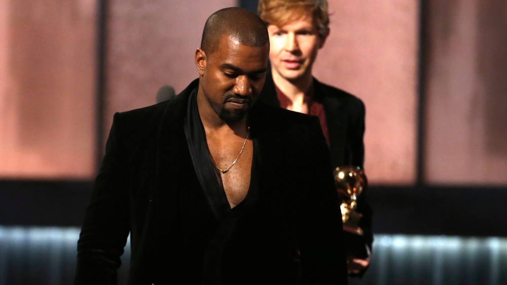 Beck watches Kanye West, who pretended to take the stage after Beck won album of the year for "Morning Phase," at the 57th annual Grammy Awards in Los Angeles, Calif., on Feb. 8, 2015. (Photo by Lucy Nicholson/Reuters)