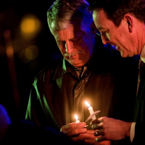 Carl Mueller holds his candle during a candlelight memorial honoring his daughter aid worker Kayla Mueller at the Prescott's Courthouse Square in Prescott, Ariz., Feb. 18, 2015. (Photo by Deanna Dent/Reuters)