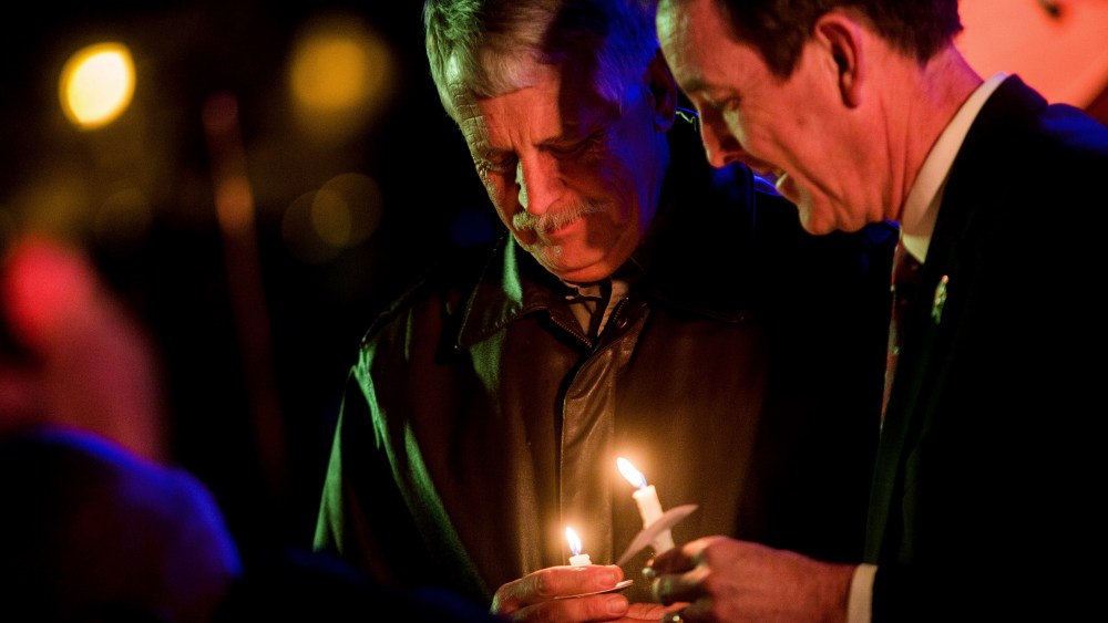 Carl Mueller holds his candle during a candlelight memorial honoring his daughter aid worker Kayla Mueller at the Prescott's Courthouse Square in Prescott, Ariz., Feb. 18, 2015. (Photo by Deanna Dent/Reuters)