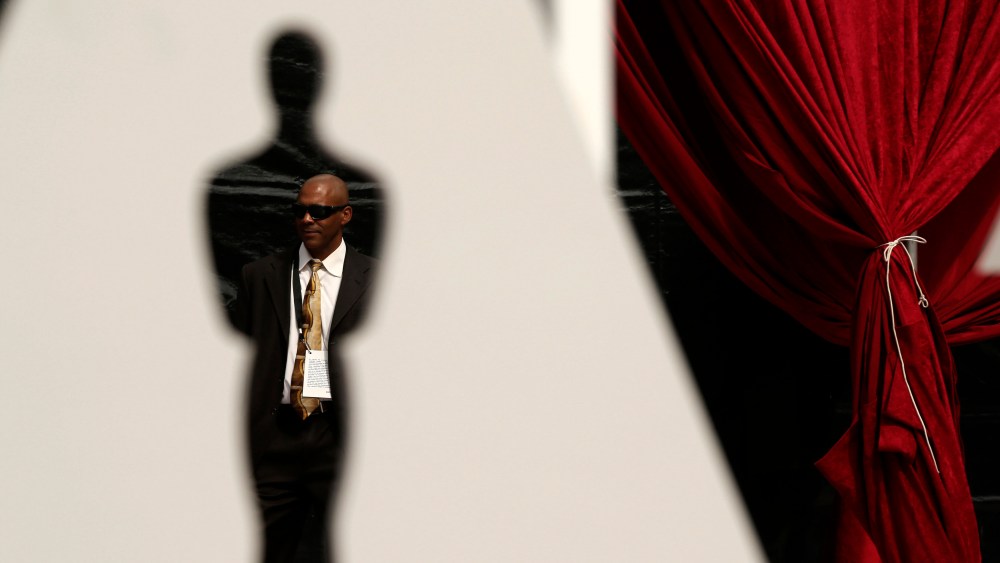 A man is framed by an Oscar cutout on the red carpet during preparations ahead of the 87th Academy Awards in Hollywood, California Feb. 20, 2015. (Photo by Robert Galbraith/Reuters)