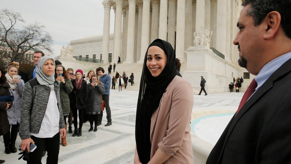 Muslim woman Samantha Elauf (C), who was denied a sales job at an Abercrombie Kids store in Tulsa in 2008, stands between her mother Majda (L) and EEOC General Counsel David Lopez (R) outside the U.S. Supreme Court in Washington, D.C., Feb. 25, 2015.