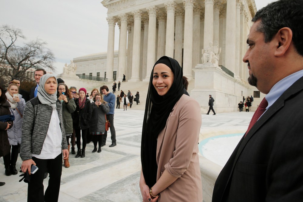 Muslim woman Samantha Elauf (C), who was denied a sales job at an Abercrombie Kids store in Tulsa in 2008, stands between her mother Majda (L) and EEOC General Counsel David Lopez (R) outside the U.S. Supreme Court in Washington, D.C., Feb. 25, 2015.