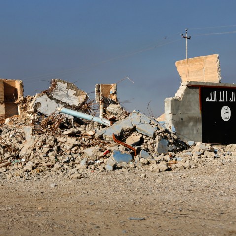 A destroyed building with a wall painted with the black flag commonly used by Islamic State militants is seen, March 10, 2015. (Photo by Thaier Al-Sudani/Reuters)