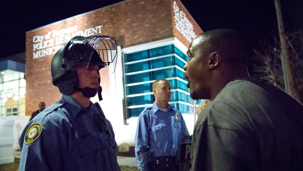 A protester confronts a police officer outside the City of Ferguson Police Department and Municipal Court in Ferguson, Missouri, March 11, 2015. (Photo by Kate Munsch/Reuters)