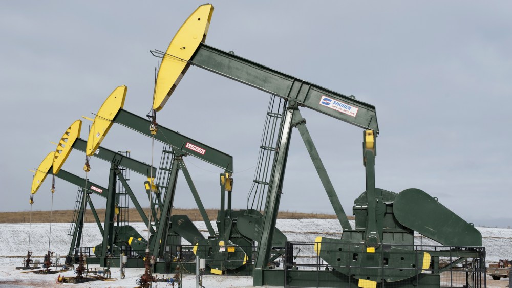 Pumpjacks taken out of production temporarily stand idle at a Hess site while new wells are fracked near Williston, ND, Nov. 12, 2014. (Photo by Andrew Cullen/Reuters)
