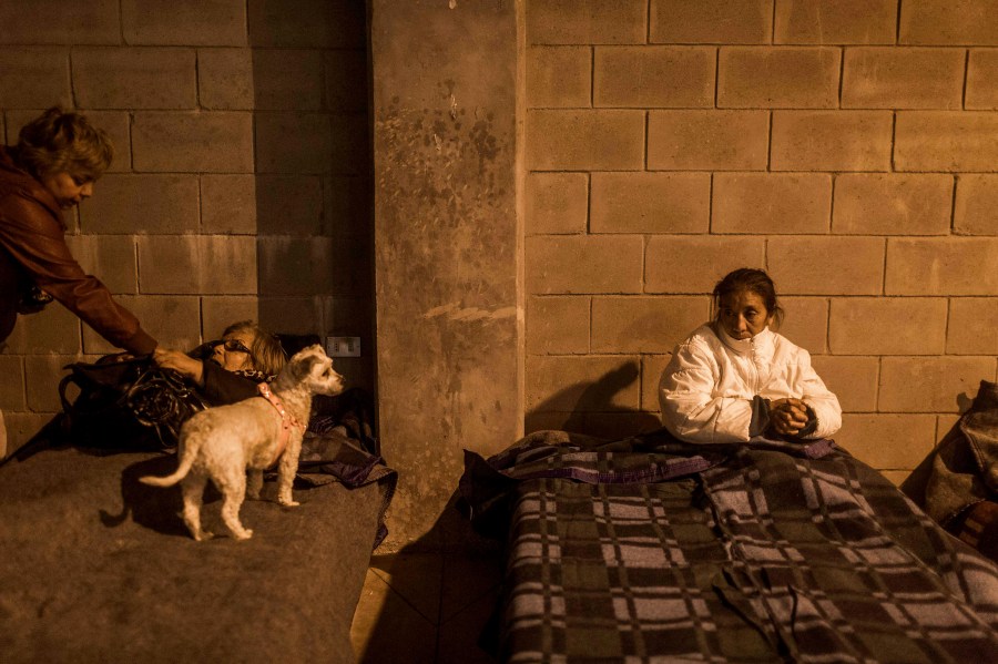 Locals rest in a shelter during a forest fire in the hills of the port city of Valparaiso, Chile, March 14, 2015. Thousands of people were evacuated from around Valparaiso on Friday as a forest fire raged out of control. (Photo by Pablo Sanhueza/Reuters)