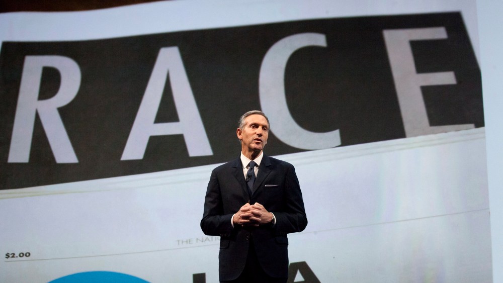 Starbucks Corp Chief Executive Howard Schultz, pictured with images from the company's new "Race Together" project behind him, speaks during the company's annual shareholder's meeting in Seattle, Washington March 18, 2015. (Photo by David Ryder/Reuters)