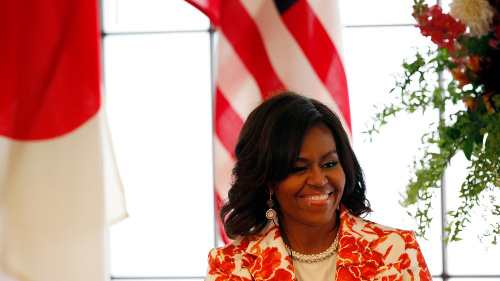 First Lady Michelle Obama smiles as she attends an event discussing education for girls at the Iikura Guest House in Tokyo March 19, 2015. (Photo by Issei Kato/Reuters)