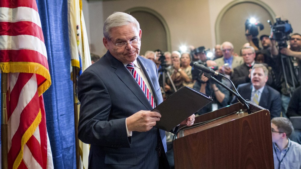 Senator Menendez exits the podium after speaking to the media during a news conference in Newark