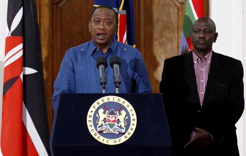 Kenyan President Uhuru Kenyatta (L), flanked by his Deputy William Ruto, addresses a news conference at the State House in the capital Nairobi April 4, 2015. (Photo by Thomas Mukoya/Reuters)