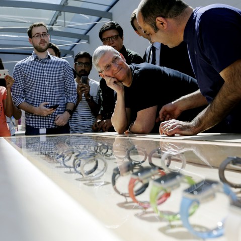 Apple CEO Tim Cook looks over a selection of Apple Watches in Palo Alto, Calif., April 10, 2015. (Photo by Robert Galbraith/Reuters)