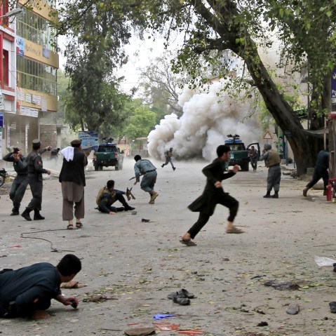 People run for cover after an explosion in Jalalabad April 18, 2015. A suicide bomb blast in Afghanistan's eastern city killed 33 people and injured more than 100 outside a bank where government workers collect salaries. (Photo by Parwiz/Reuters)