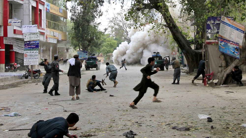 People run for cover after an explosion in Jalalabad April 18, 2015. A suicide bomb blast in Afghanistan's eastern city killed 33 people and injured more than 100 outside a bank where government workers collect salaries. (Photo by Parwiz/Reuters)