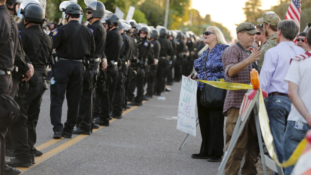 A police line separates people attending the "Freedom of Speech Rally Round II" from counter demonstrators outside the Islamic Community Center in Phoenix, Ariz. on May 29, 2015. (Photo by Nancy Wiechec/Reuters)