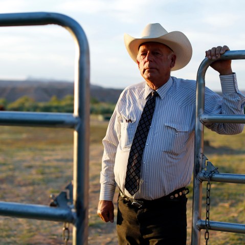 Rancher Cliven Bundy stands near a metal gate on his 160 acre ranch in Bunkerville, Nevada May 3, 2014.
