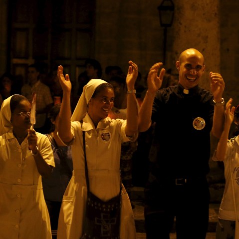 A priest and nuns gather during a prayer vigil in front of Havana's cathedral Sept. 18, 2015, as the island waits on Pope Francis to arrive. (Photo by Carlos Garcia Rawlins/Reuters)