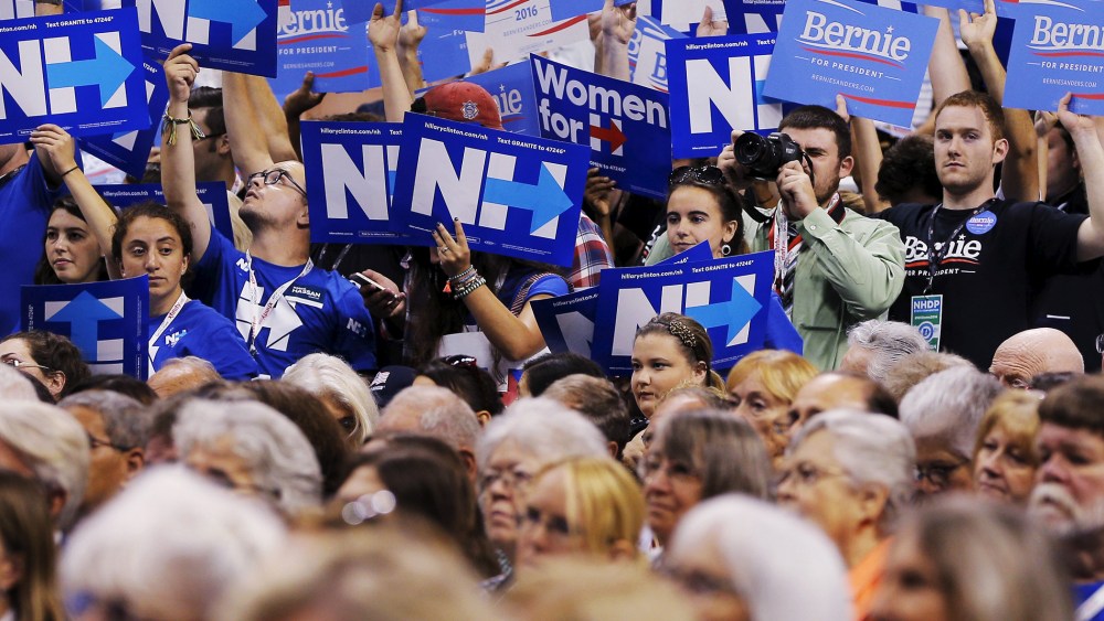 A divided crowd of supporters hold up signs at the New Hampshire Democratic Party State Convention in Manchester, NH. Sept. 19, 2015. (Photo by Brian Snyder/Reuters)