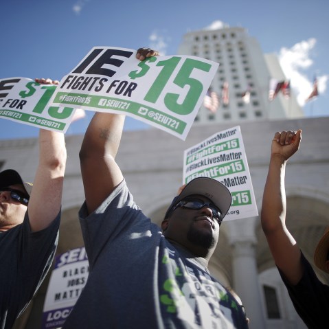 Fast-food workers and their supporters join a nationwide protest for higher wages and union rights outside City Hall in Los Angeles, Calif, Nov. 10, 2015. (Photo by Lucy Nicholson/Reuters