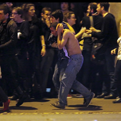 An injured man holds his head as people gather near the Bataclan concert hall following fatal shootings in Paris, France, Nov. 13, 2015. (Photo by Christian Hartmann/Reuters)