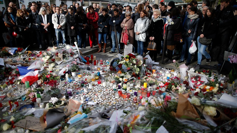 People observe a minute of silence outside the Bataclan music hall to pay tribute to the victims of the series of deadly attacks, in Paris, France, Nov. 16, 2015. (Photo by Christian Hartmann/Reuters)