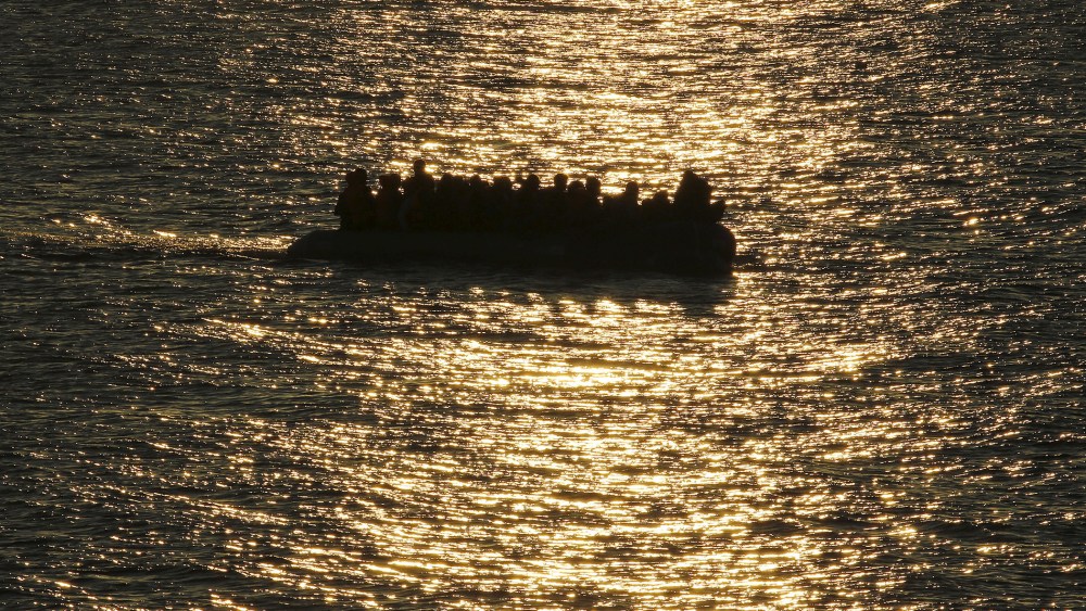 A raft overcrowded with migrants and refugees approaches a beach at dawn on the Greek island of Lesbos Nov. 17, 2015. (Photo by Yannis Behrakis/Reuters)