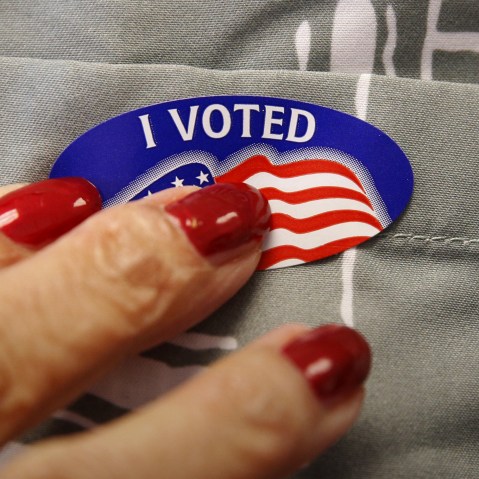 A voter receives a sticker from a polling station worker after he cast his ballot in the Super Tuesday election at Sleepy Hollow Elementary School in Falls Church, Va, March 1, 2016. (Photo by Kevin Lamarque/Reuters)