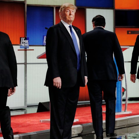 Republican presidential candidate Donald Trump remains standing at the front of the stage as his rivals head to their podiums at the start of a debate in Detroit, Mich., March 3, 2016. (Photo by Jim Young/Reuters)