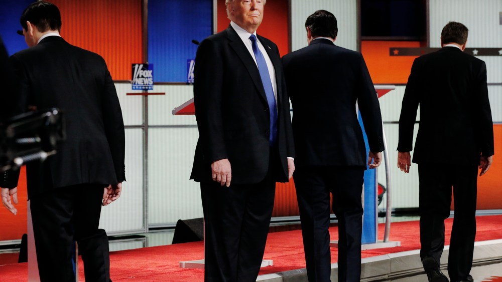Republican presidential candidate Donald Trump remains standing at the front of the stage as his rivals head to their podiums at the start of a debate in Detroit, Mich., March 3, 2016. (Photo by Jim Young/Reuters)