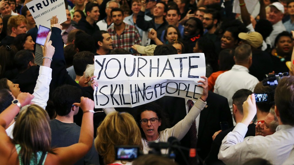 A protestor holds up a sign reading "Your Hate is Killing People" in the midst of Donald Trump's campaign rally in New Orleans, La., March 4, 2016. (Photo by Stringer/Reuters)
