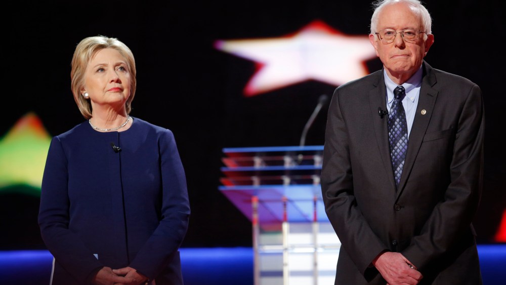 Democratic U.S. presidential candidates Hillary Clinton and Bernie Sanders pose together onstage at the start of the U.S. Democratic presidential candidates' debate in Flint, Mich. on March 6, 2016. (Photo by Carlos Barria/Reuters)