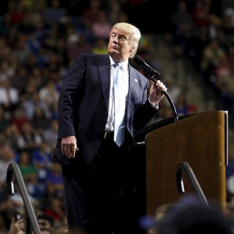 Donald Trump pauses to look at a demonstrator behind him during a campaign rally in Fayetteville, N.C., March 9, 2016. (Photo by Jonathan Drake/Reuters)