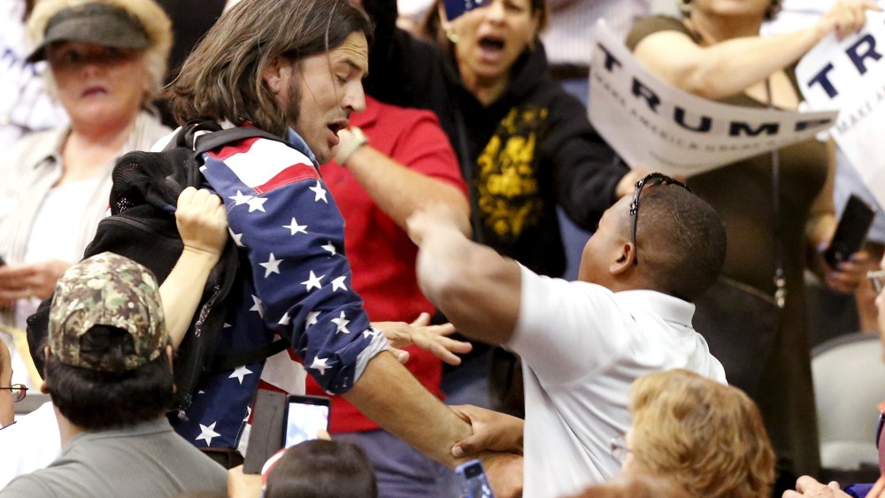 A member of the audience (R) throws a punch at a protester as Republican Presidential candidate Donald Trump speaks during a campaign event in Tucson, Ariz., March 19, 2016. (Photo by Sam Mircovich/Reuters)