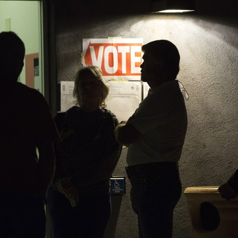 Early morning voters stand in line before sunrise to vote, March 22, 2016. (Photo by Nancy Wiechec/Reuters)