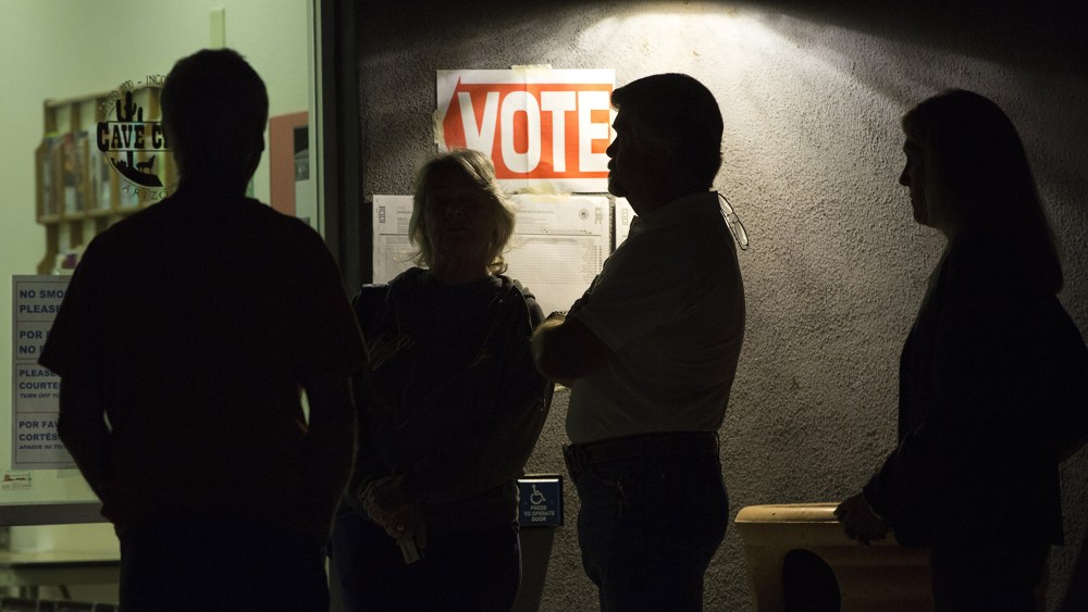 Early morning voters stand in line before sunrise to vote, March 22, 2016. (Photo by Nancy Wiechec/Reuters)