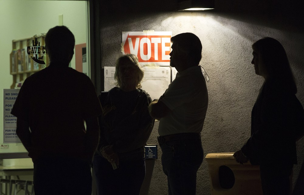 Early morning voters stand in line before sunrise to vote, March 22, 2016. (Photo by Nancy Wiechec/Reuters)