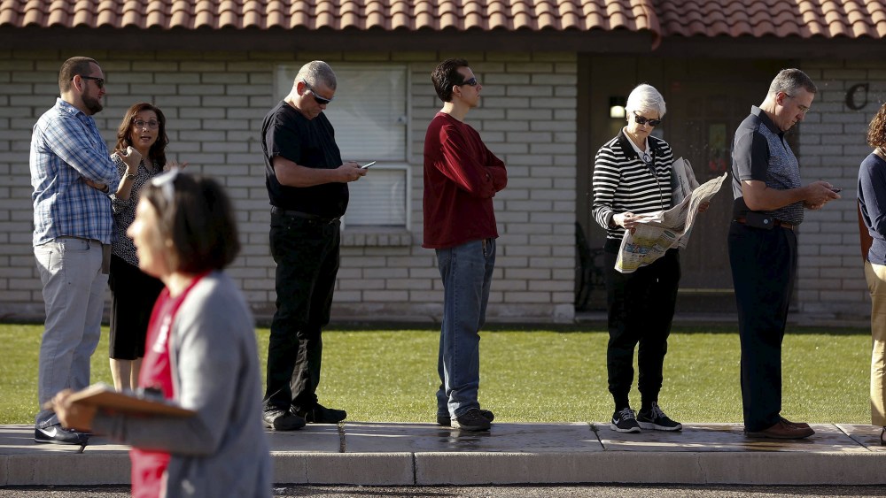 People wait to vote in the presidential primary election outside a polling site in Glendale, Ariz., March 22, 2016. (Photo by Nancy Wiechec/Reuters)