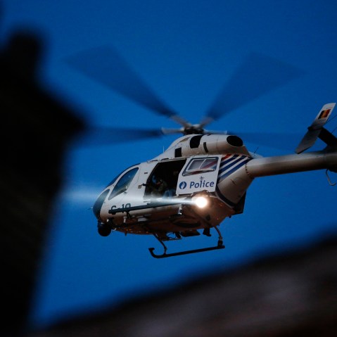 A police helicopter hovers over Brussels' rooftops following bomb attacks in Brussels, Belgium, March 22, 2016. (Photo by Christian Hartmann/Reuters)