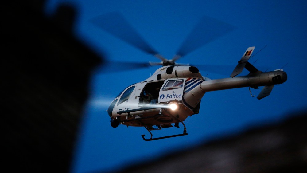 A police helicopter hovers over Brussels' rooftops following bomb attacks in Brussels, Belgium, March 22, 2016. (Photo by Christian Hartmann/Reuters)