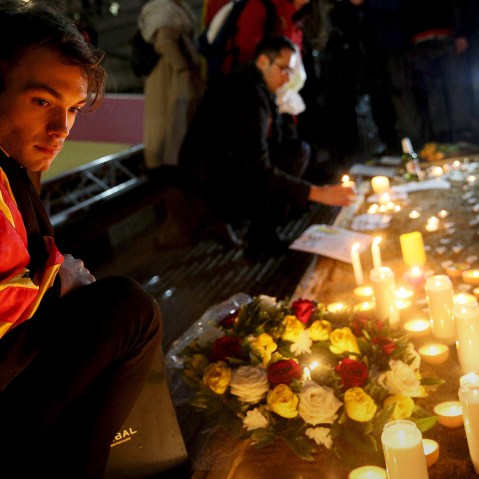 A man looks at candles during a vigil for the victims of the Brussels bomb attacks, at Trafalgar Square in London, Britain, March 24, 2016. (Photo by Neil Hall/Reuters)