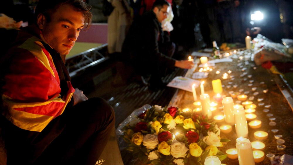 A man looks at candles during a vigil for the victims of the Brussels bomb attacks, at Trafalgar Square in London, Britain, March 24, 2016. (Photo by Neil Hall/Reuters)